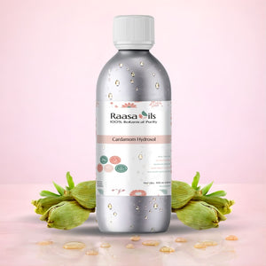 Bottle of Raasa Oils Cardamom Hydrosol with cardamom pods on a pink background