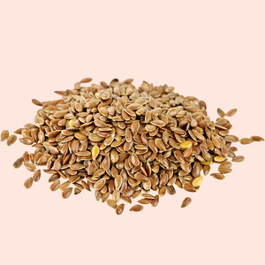Pile of flaxseeds on a beige background