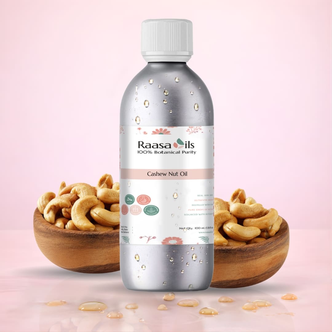 Bottle of Raasa Oils Cashew Nut Oil with cashew nuts on a pink background