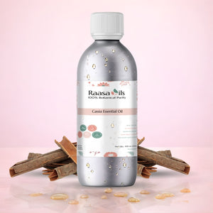 Raasa Oils Cassia Essential Oil bottle with cinnamon sticks on a pink background