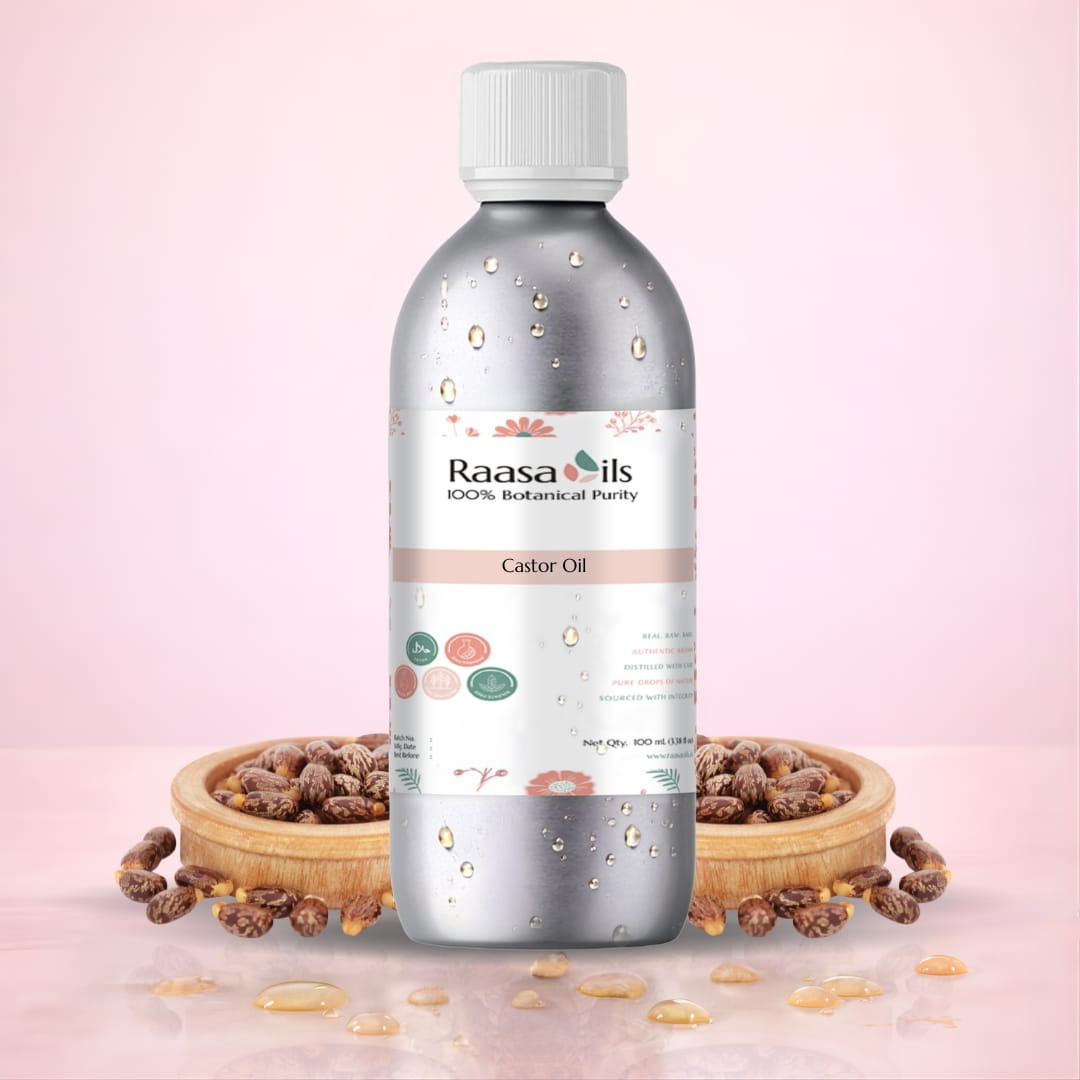 Bottle of Raasa Oils Castor Oil with castor seeds on a pink background