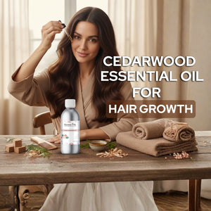 Woman with long hair sitting at a table with a bottle of cedarwood essential oil for hair growth.