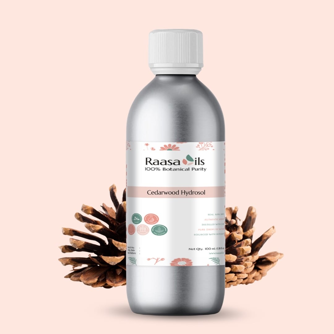 Bottle of Raasa Oils Cedarwood Hydrosol with decorative elements on a light pink background