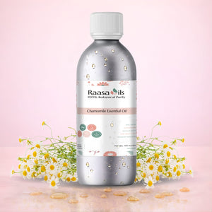 Raasa Oils chamomile essential oil bottle with flowers on a pink background