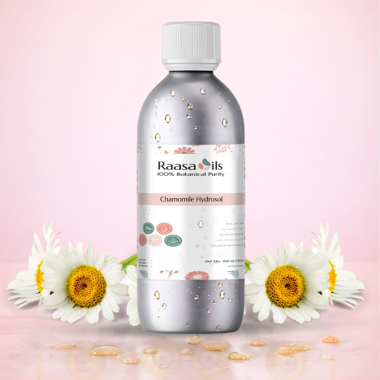 Raasa Oils bottle with chamomile flowers on a pink background