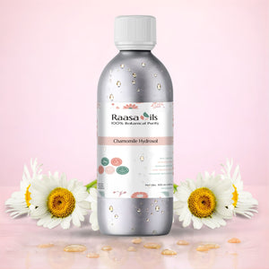 Raasa Oils bottle with chamomile flowers on a pink background