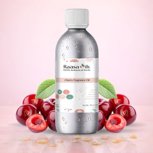 Bottle of Raasa Oils Cherry Fragrance Oil with cherries on a pink background