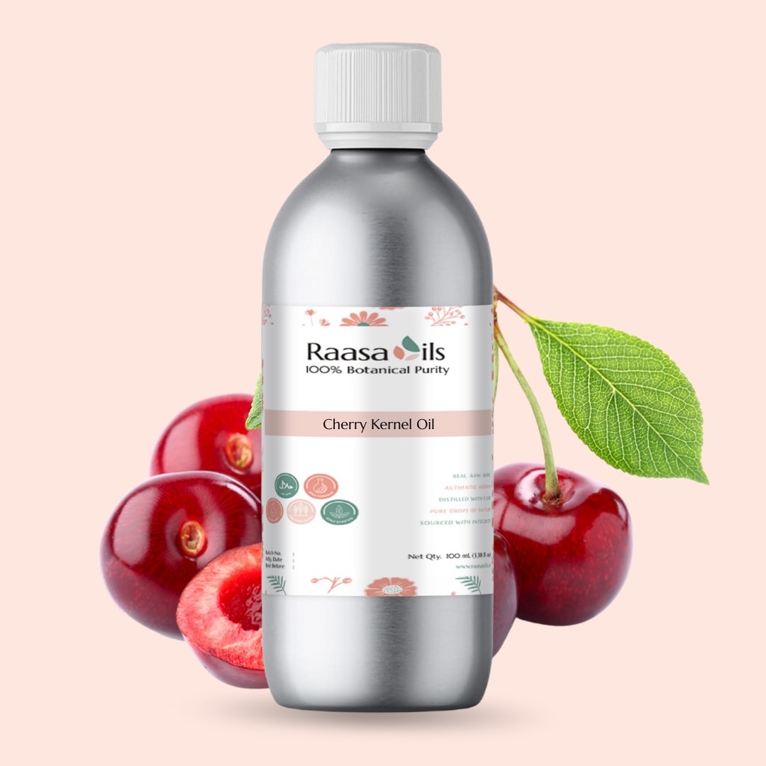 Bottle of Raasa Oils Cherry Kernel Oil with cherries and a leaf on a light pink background