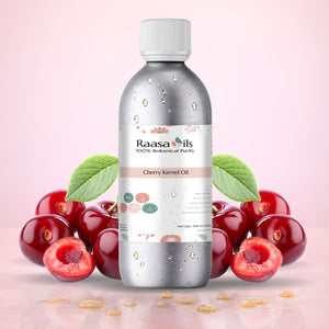 Bottle of Raasa Oils Cherry Kernel Oil with cherries on a pink background
