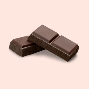 Two dark chocolate bars on a beige background