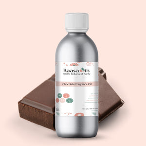 Bottle of Raasa Oils Chocolate Fragrance Oil with a piece of chocolate on a beige background