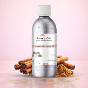 Raasa Oils Cinnamon Bark Essential Oil bottle with cinnamon sticks and powder on a pink background