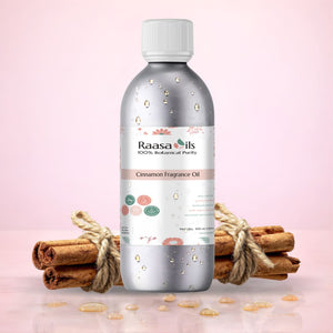 Bottle of Raasa Oils Cinnamon Fragrance Oil with cinnamon sticks on a pink background