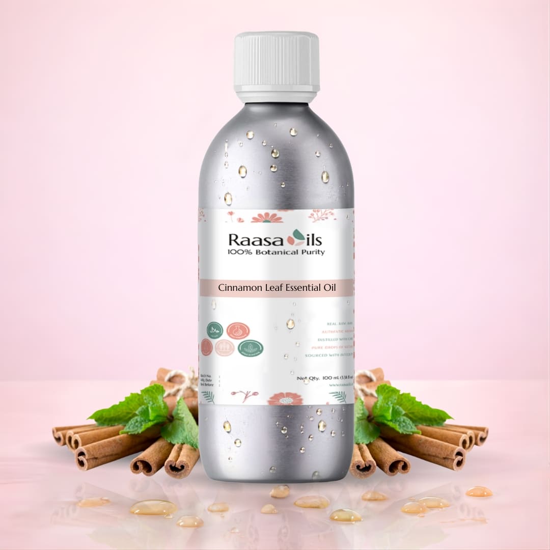 Raasa Oils Cinnamon Leaf Essential Oil bottle with cinnamon sticks and leaves on a pink background