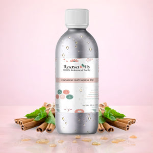 Raasa Oils Cinnamon Leaf Essential Oil bottle with cinnamon sticks and leaves on a pink background