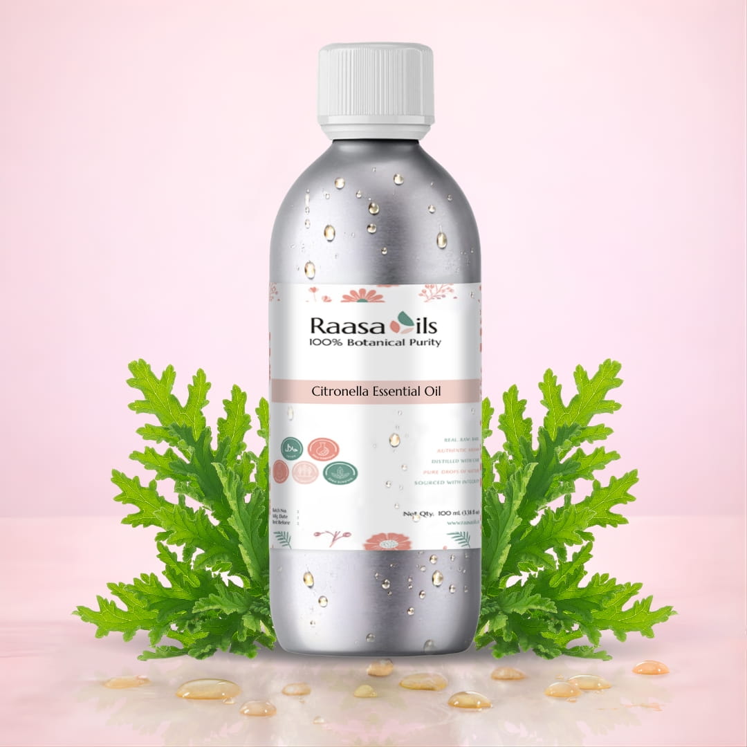 Bottle of Raasa Oils Citronella Essential Oil with green leaves on a pink background