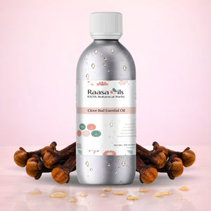 Bottle of Raasa Oils Clove Bud Essential Oil with clove buds on a pink background