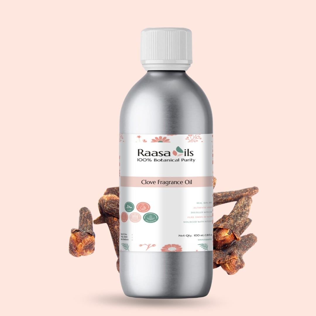 Bottle of Raasa Oils Clove Fragrance Oil with clove buds on a light pink background
