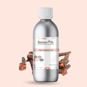 Bottle of Raasa Oils Clove Fragrance Oil with clove buds on a light pink background