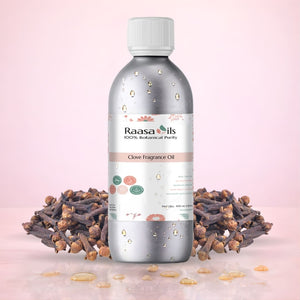 Raasa Oils clove fragrance oil bottle with cloves on a pink background