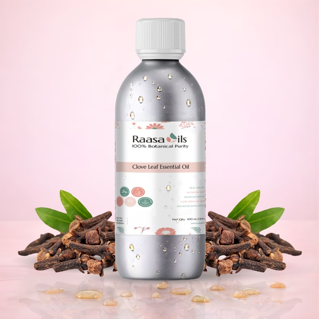Raasa Oils Clove Leaf Essential Oil bottle with clove buds on a pink background