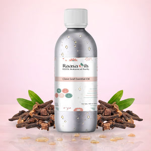 Raasa Oils Clove Leaf Essential Oil bottle with clove buds on a pink background