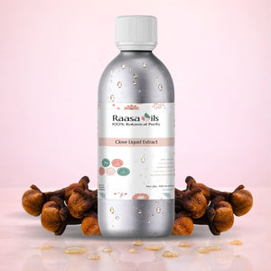 Bottle of Raasa Oils Clove Liquid Extract with cloves on a pink background