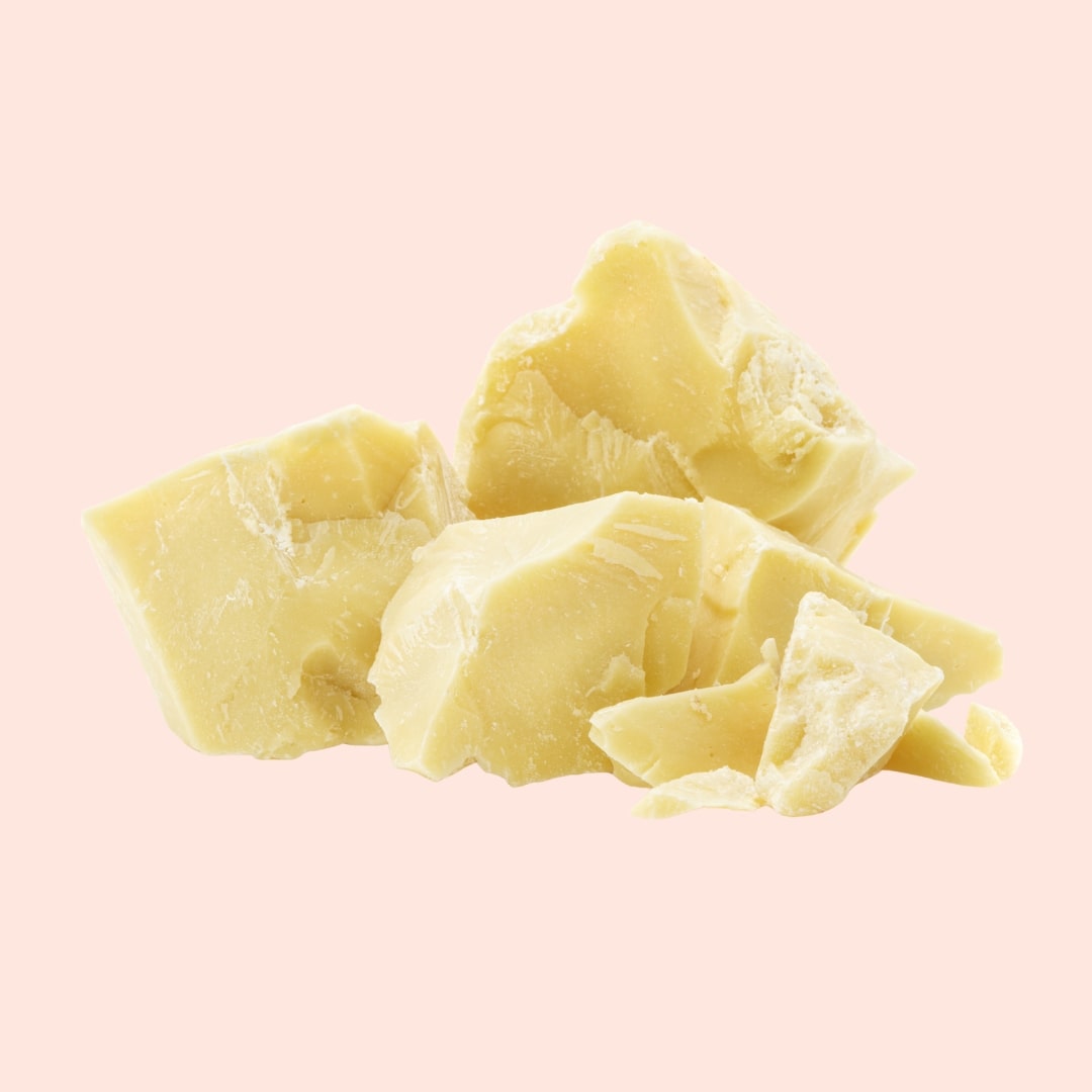 Chunks of yellowish-white material on a pink background