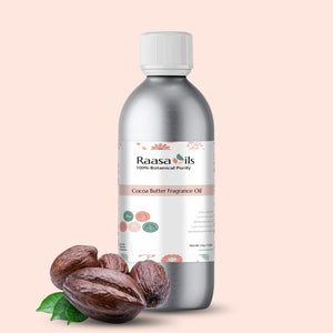 Bottle of Raasa Oils Cocoa Butter Fragrance Oil with cocoa butter and leaves on a beige background