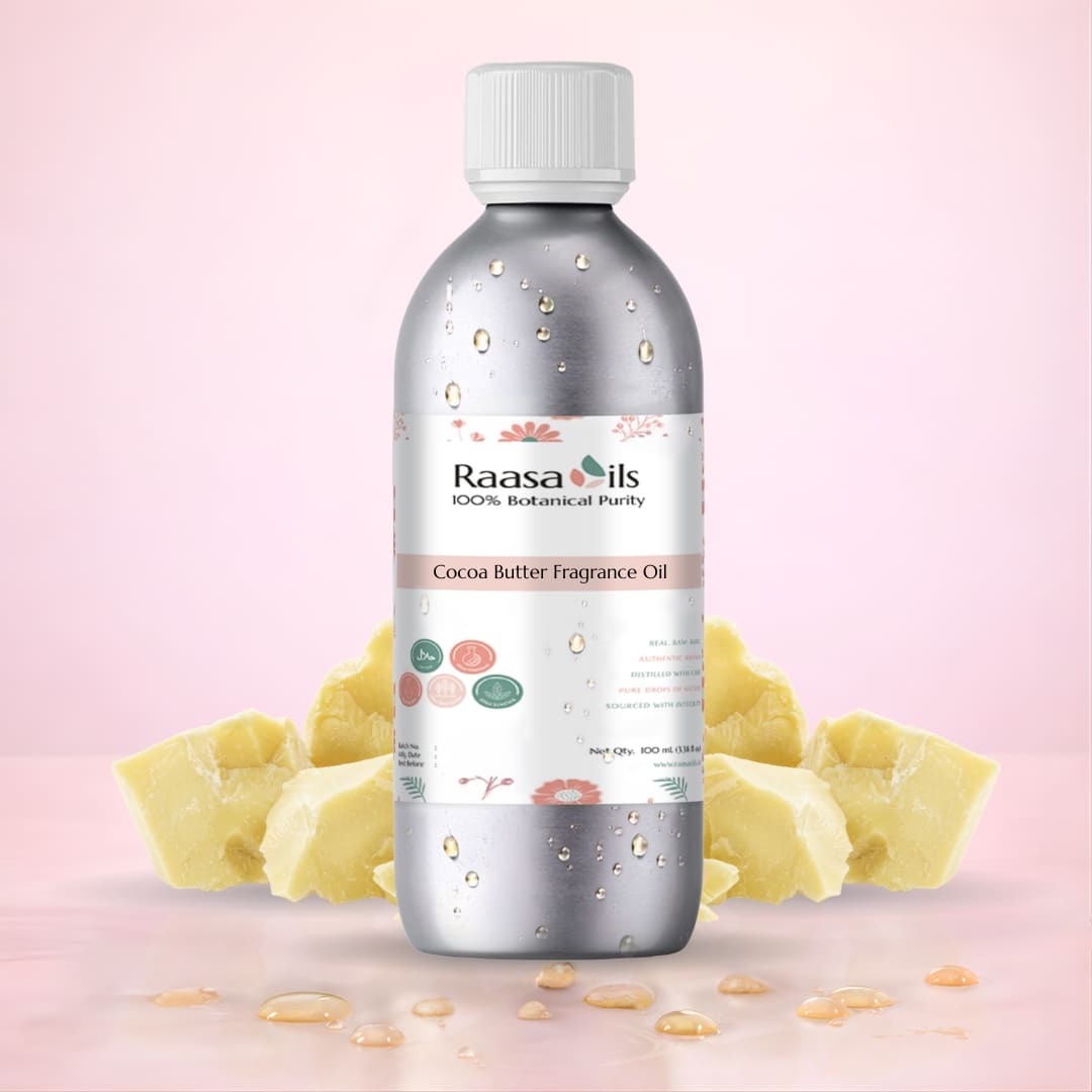 Bottle of Raasa Oils Cocoa Butter Fragrance Oil with cocoa butter pieces on a pink background