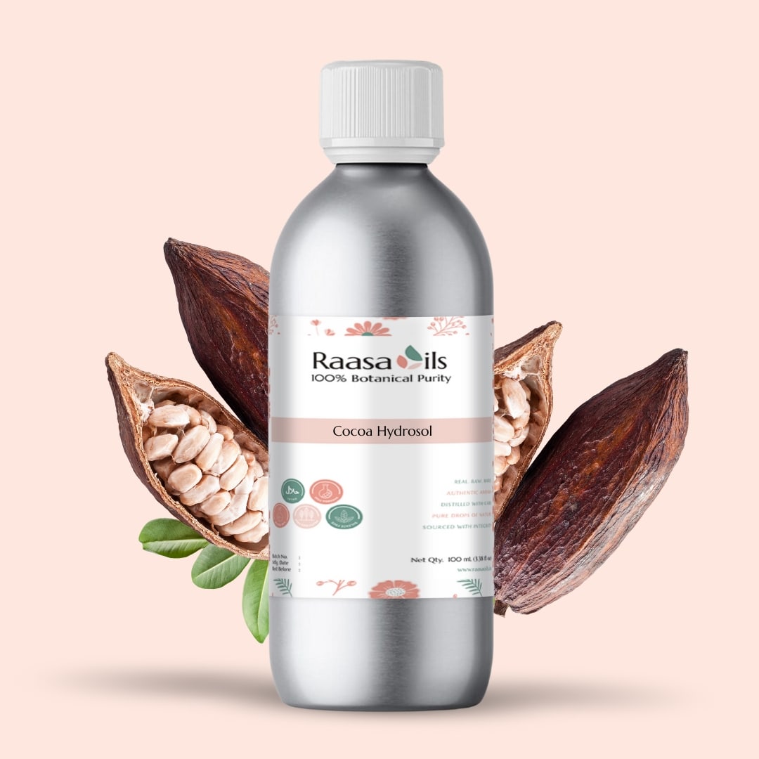 Bottle of Raasa Oils Cocoa Hydrosol with cocoa beans and pod on a beige background