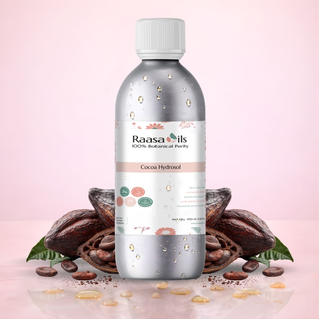 Bottle of Raasa Oils Cocoa Hydrosol with cocoa beans on a pink background