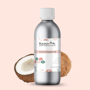 Bottle of Raasa Oils coconut fragrance oil with coconuts on a light pink background