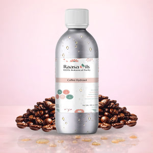 Bottle of Raasa Oils Coffee Hydrosol with coffee beans on a pink background
