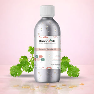 Bottle of Raasa Oils Coriander Essential Oil with coriander leaves on a pink background