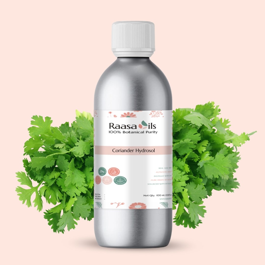 Bottle of Raasa Oils Coriander Hydrosol with coriander leaves on a light pink background