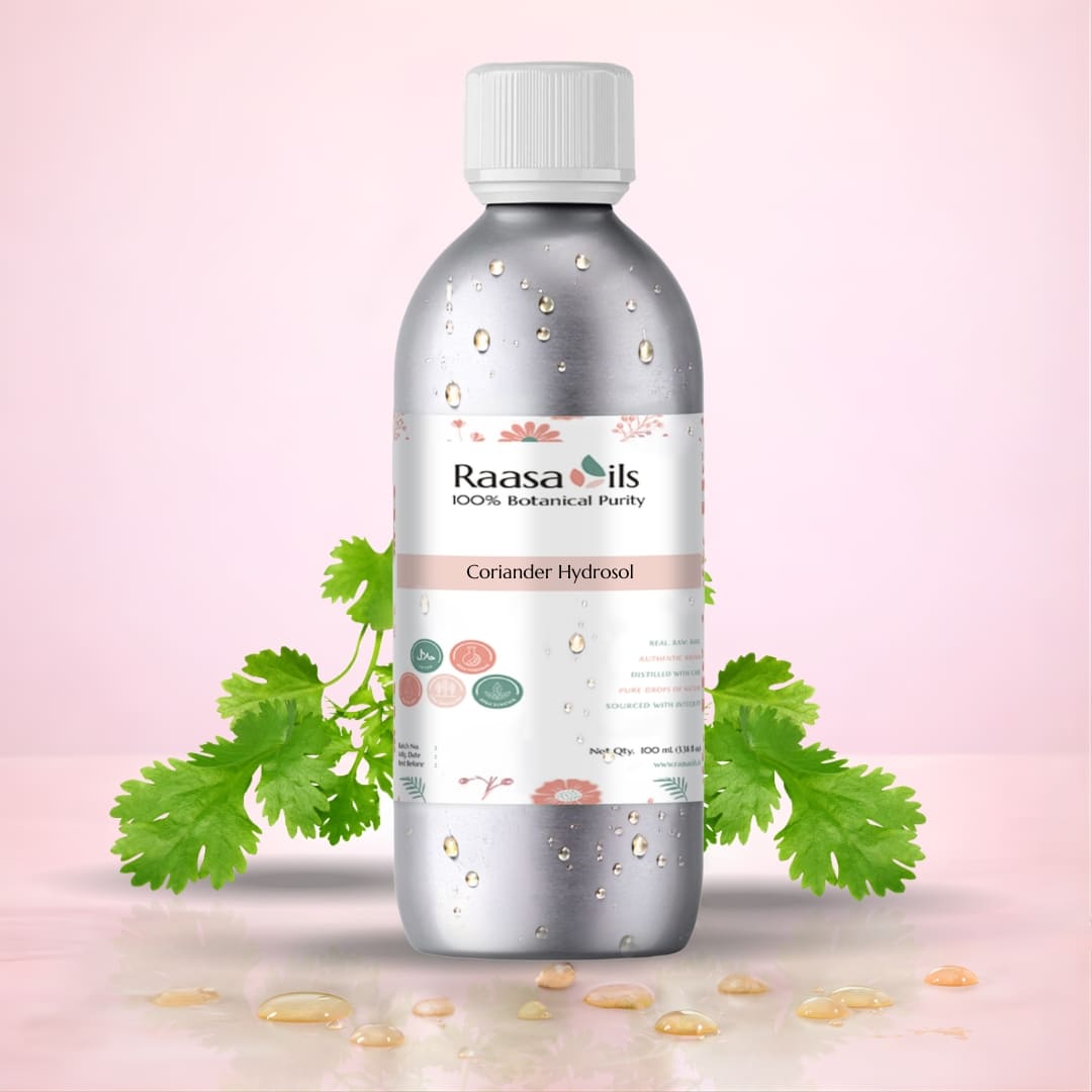 Bottle of Raasa Oils Coriander Hydrosol with coriander leaves on a pink background