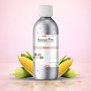 Bottle of Raasa Oils corn oil with corn kernels on a pink background