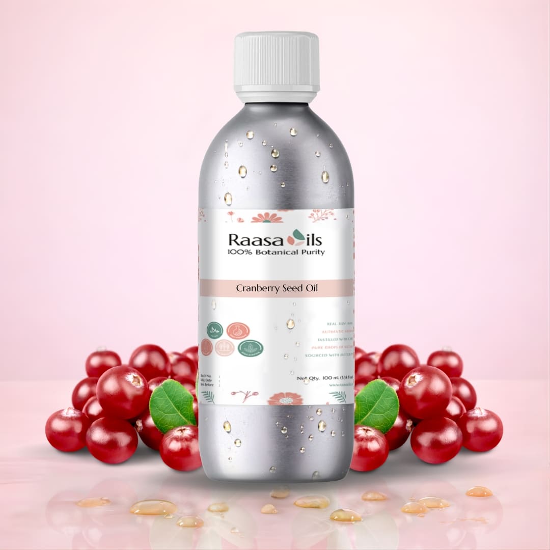 Bottle of Raasa Oils Cranberry Seed Oil with cranberries on a pink background