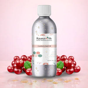 Bottle of Raasa Oils Cranberry Seed Oil with cranberries on a pink background
