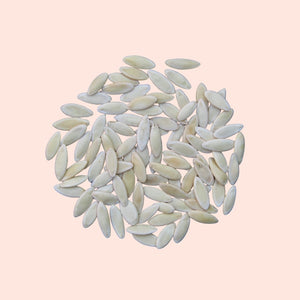 White rice grains on a light pink background