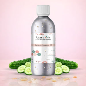 Bottle of Raasa Oils Cucumber Fragrance Oil with cucumbers on a pink background