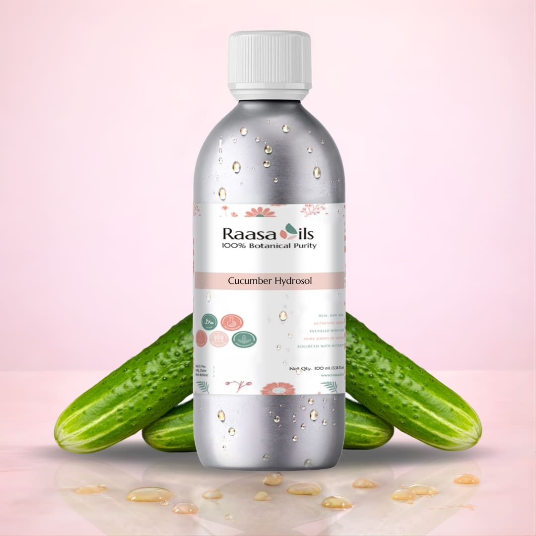Bottle of Raasa Oils Cucumber Hydrosol with cucumbers on a pink background