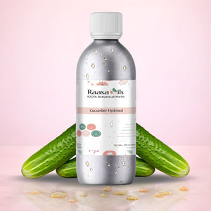 Bottle of Raasa Oils Cucumber Hydrosol with cucumbers on a pink background