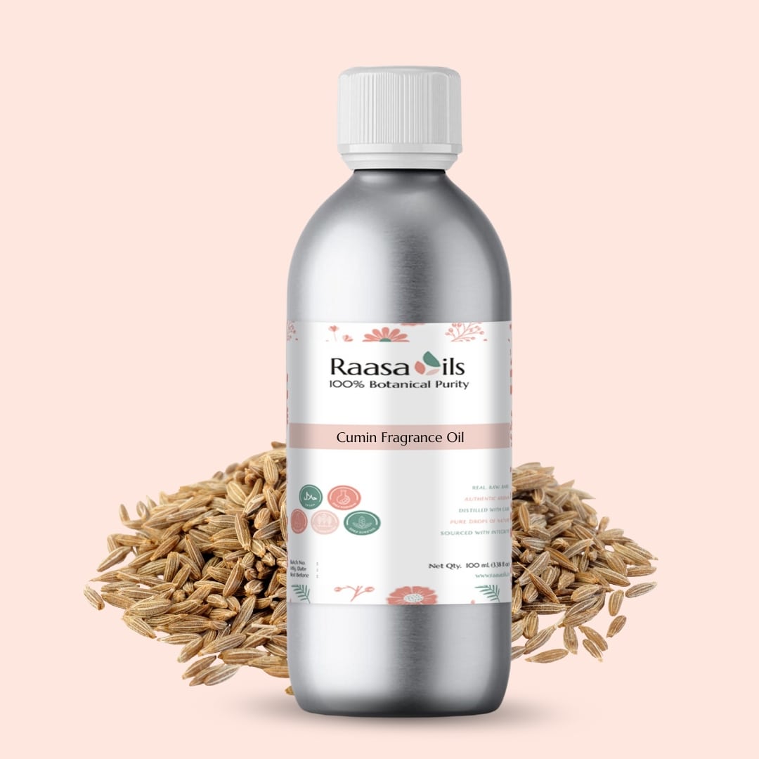 Bottle of Raasa Oils Cumin Fragrance Oil with cumin seeds on a light pink background