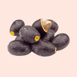 Black olives with gold tips on a beige background