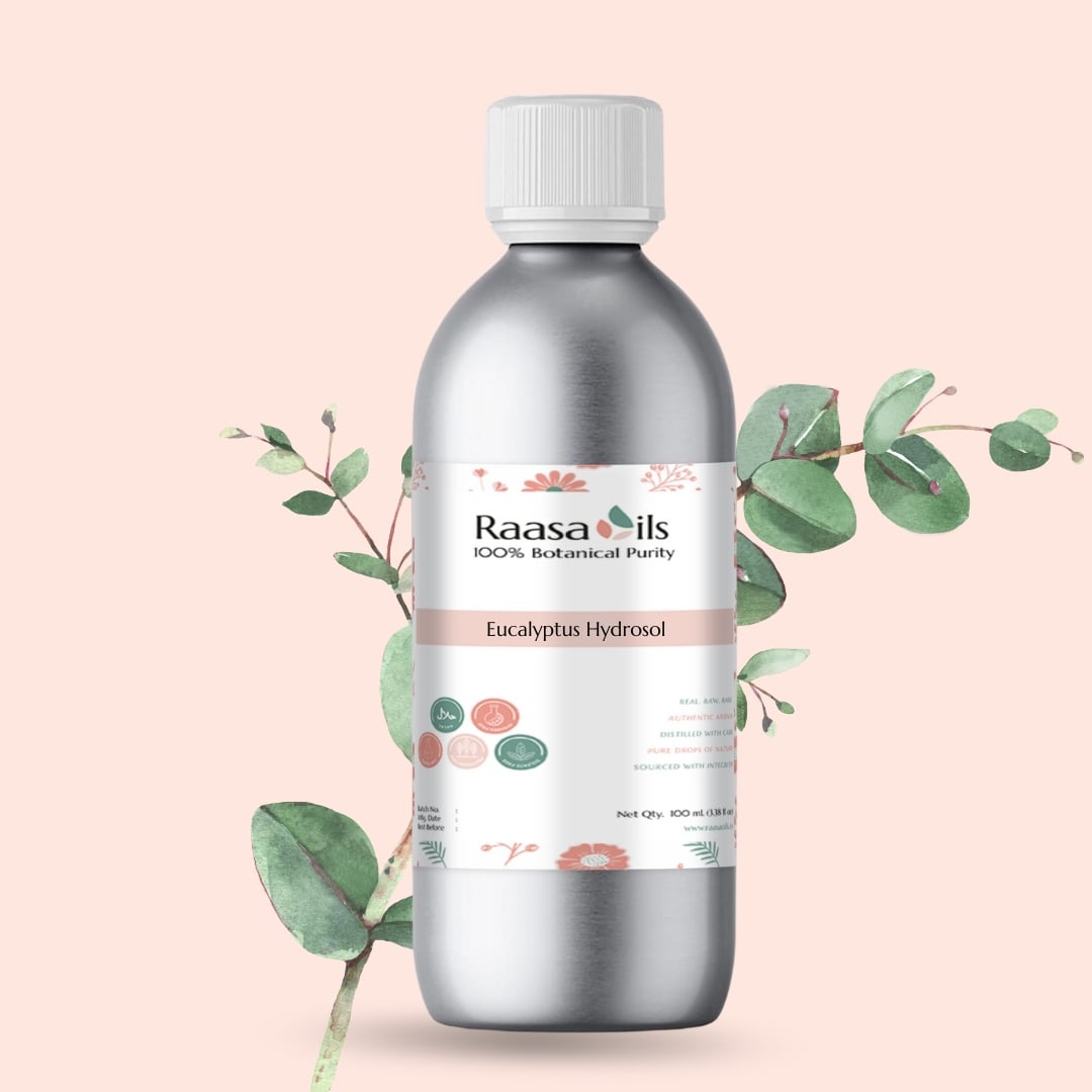 Bottle of Raasa Oils Eucalyptus Hydrosol with eucalyptus leaves on a light pink background
