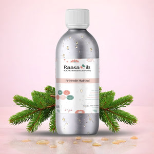 Fir Needle Hydrosol Bottle of Raasa Oils with a pink background and green leaves