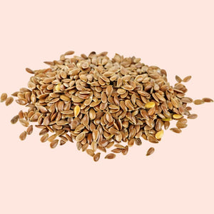 Pile of flaxseeds on a beige background