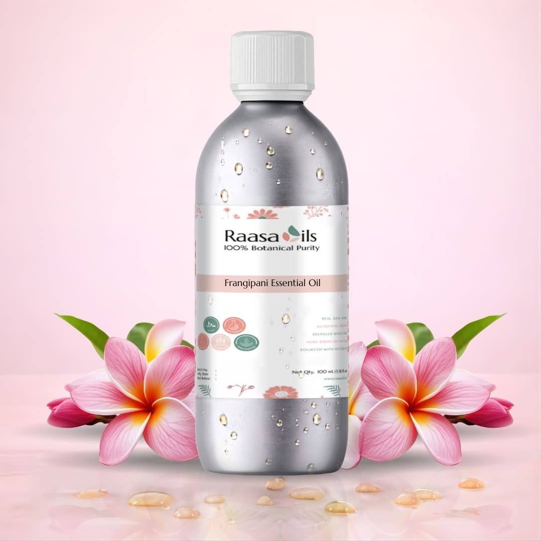 Raasa Oils frangipani essential oil bottle with flowers on a pink background